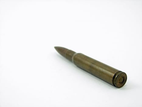 An old bullet angled against a white background.