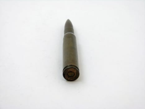 An old bullet straight against a white background.