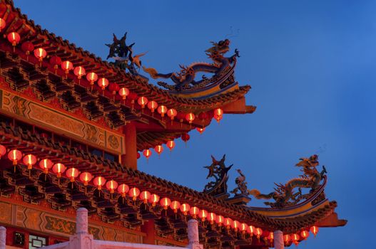 Buddhist Temple with red lantern at dusk.