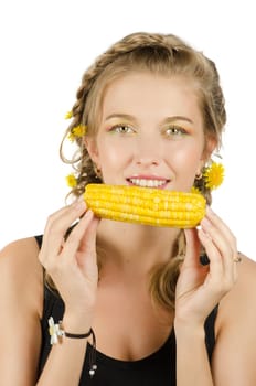 Close-up portrait of young beauty woman eating corn-cob on a white