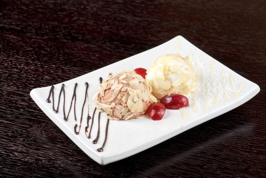 Dessert set of ice-cream with almond, chocolate and grapes