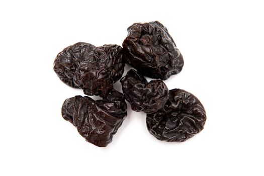 Dried plums on the white background