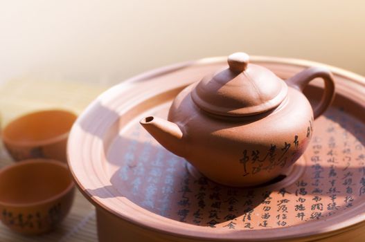 Chinese ceramic teapot and cups. The Chinese word on the pot is a poem.