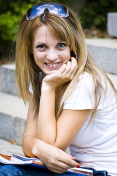 beautiful young woman reading book outdoor