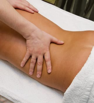 closeup of young woman getting a back massage