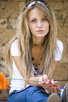 beautiful young woman with books and flower outdoor