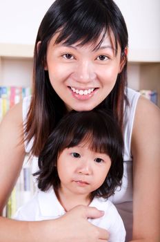 Happy young Asian mother and her daughter.