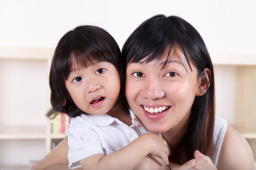 Portrait of young Asian mother and her daughter.