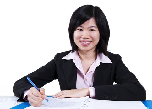 A businesswoman sitting at the table with document.