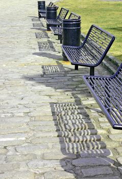 Six Iron Benches on a Cobbled Street