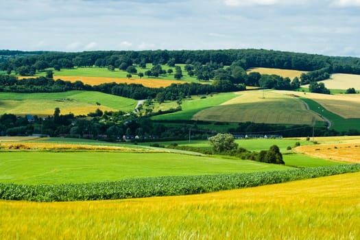 View over hills with villages, maize- and  grainfields in summer