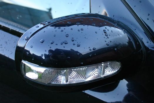 Dark Blue Car Wing Mirror in the Wet