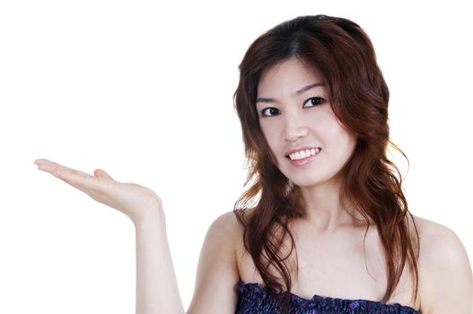 Asian woman showing empty hand, isolated in white.