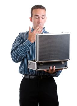 A young man dressed nicely is surprised at what he sees in a case he is holding, isolated against a white background