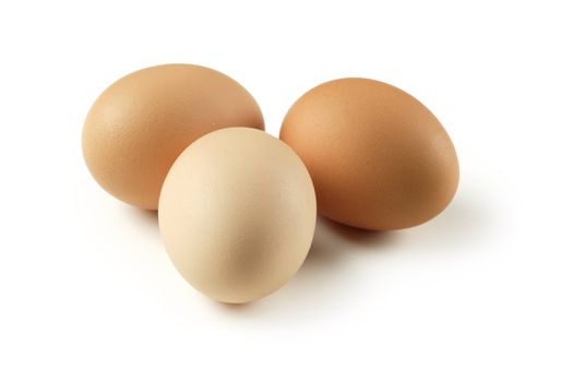 Brown eggs isolated on a white background.  Slight extended shadow to the right is visible.