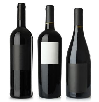 Three merged photographs of different shape red wine bottles with blank labels.  Separate clipping paths for bottles and labels included.
