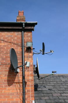 3 Small Satellite Dishes on the SIde of a House