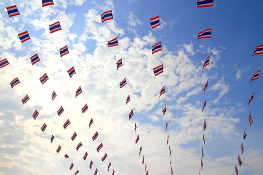 waving Thai flags hanging on a blue sky