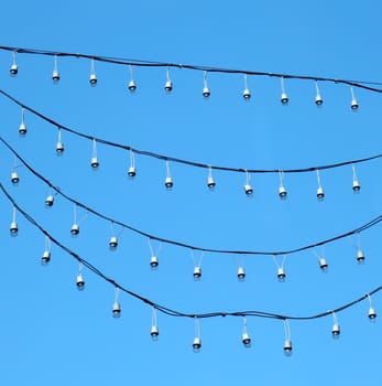 hanging holiday light over blue sky