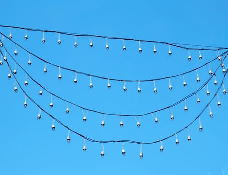 hanging holiday light over blue sky