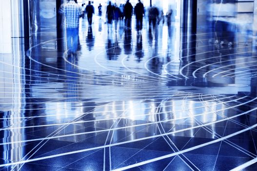 A shopping mall. Long exposure for intentional motion blur of people.