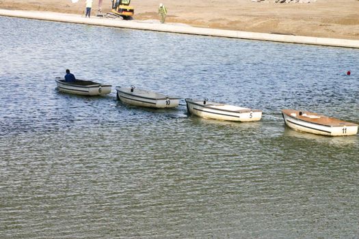 Four Numbered Motor Boats on Tow