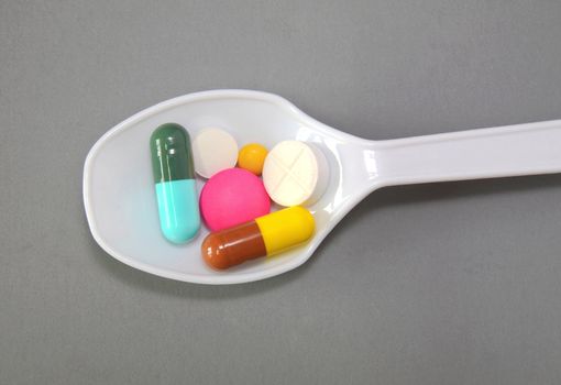 A spoonful of Pills and capsules to Keep Healthy Concept