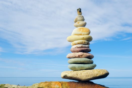Pile of pebbles in the balance on the seacoast