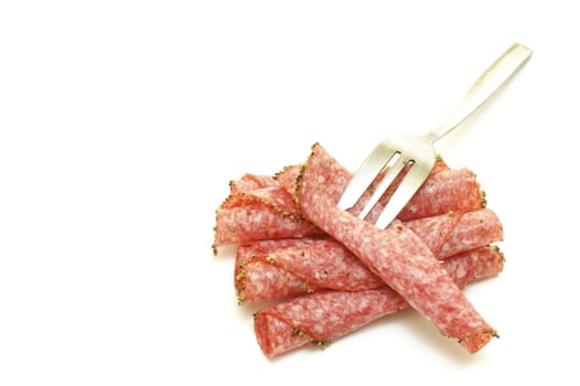 some salami slices and a fork