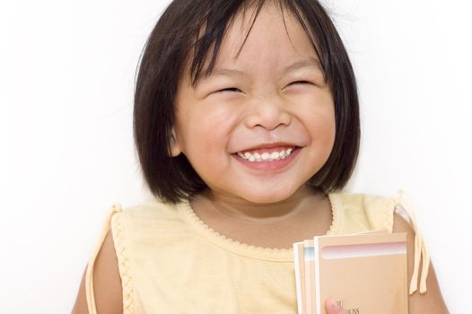 A cute Asian girl happy with her books.