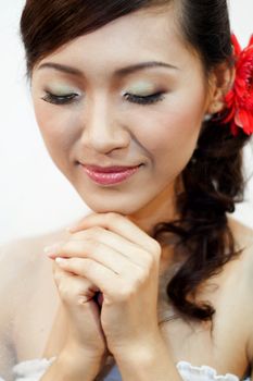 Beautiful Asian bride is praying.