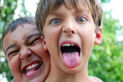 two cute boys making crazy faces outdoor
