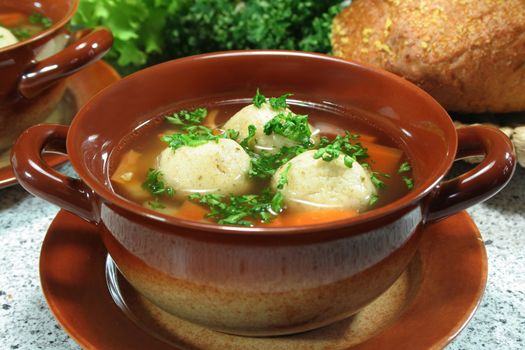 soup clear with bone marrow dumplings and parsley