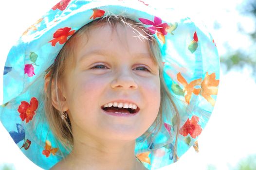 adorable little girl happy smiling on a sunny summer day