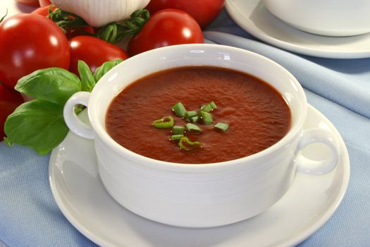 Tomato soup with basil and fresh vegetables