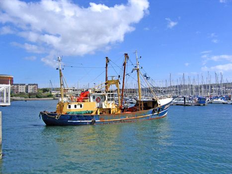 Fishing trawler leaving the lock gates at Plymouth Harbour in Devon, England