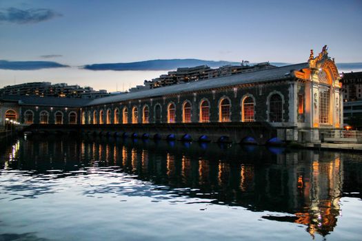 Famous batiment des Forces-Motrices on the Rhone river by night, Geneva, Switzerland