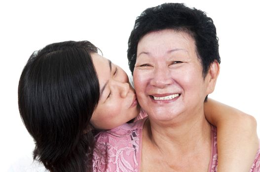 Asian Family. Daughter kissing to her mum.