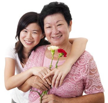 Happy Asian Mother and Daughter with carnation flower