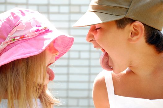 playful kids sticking their tongues at each other