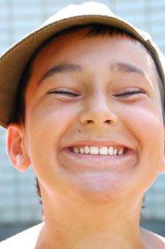 portrait of a happy young boy with a cap