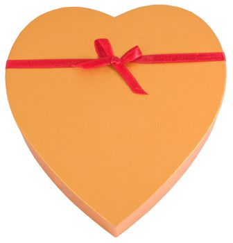 Heart shaped golden chocolate box tied with red ribbon with copyspace isolated on white