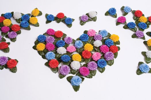 many-coloured plastics roses on a white background