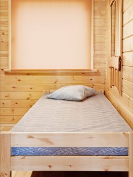 Single bed in the log house bedroom