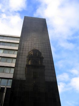 New Building in Liverpool England with Reflection of Old Historic Building in Dark Tiles