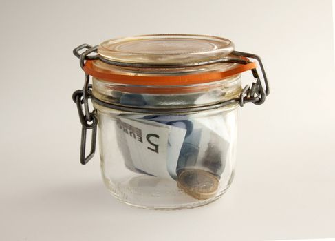 Banknotes and money in a glass jar
