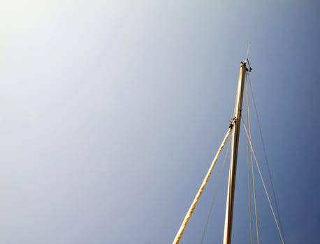 Top of tree of a ship in the blue sky