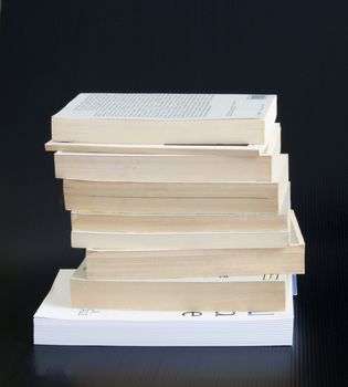 A stack of books over black background