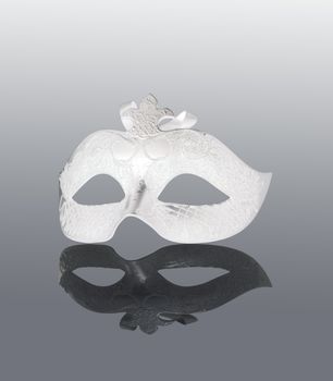 White Mask with black reflection, over gray background