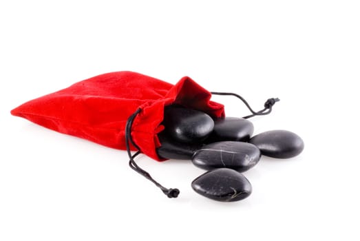 Zen stones in velvet red bag, isolated on a white background.